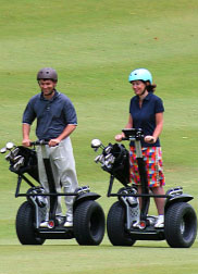 Two people riding X2 Golfs